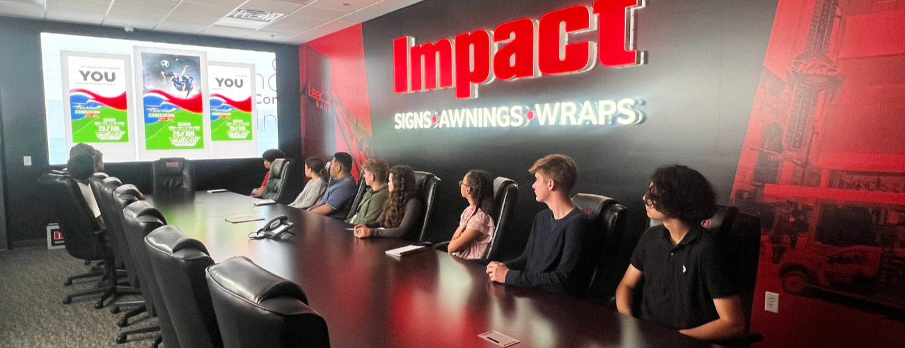 opportunities CAPS Students in the meeting room of impact watching a video that a impact employee recently created