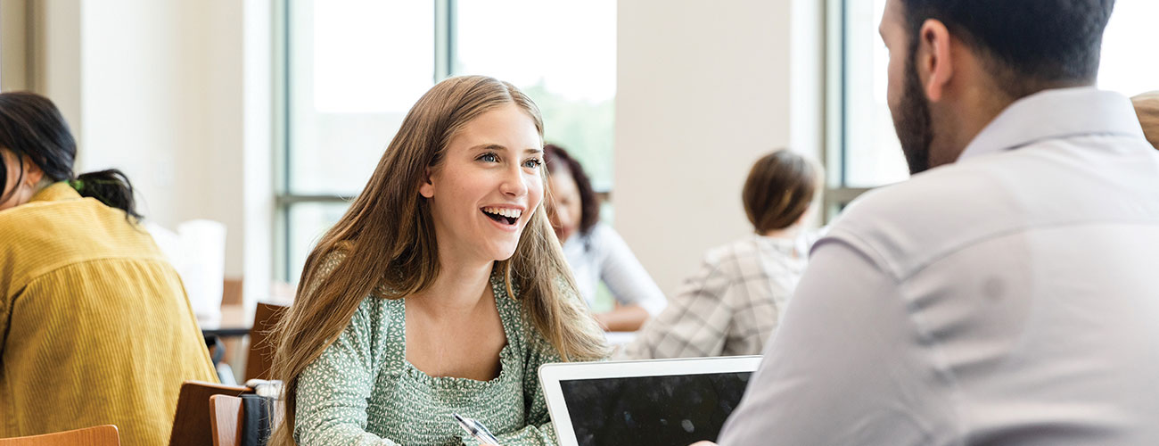 Female student learning about the Queen City CAPS program from a academic advisor