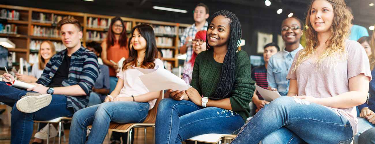 A group of students listening to a partner speak