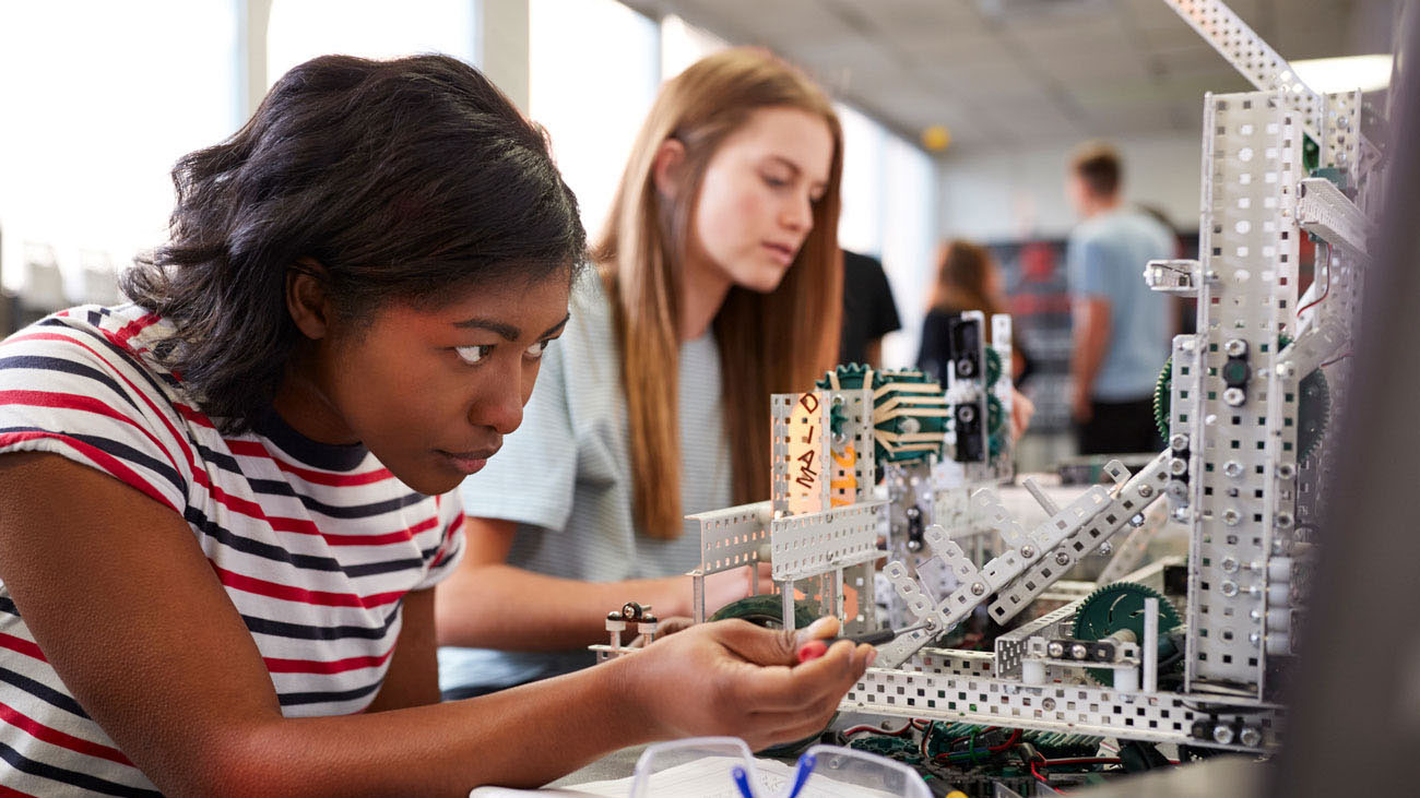 Two students working on a hands-on engineering project at CAPS